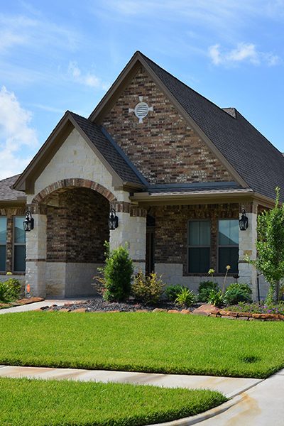 home with walkway and stone cladding huffman tx